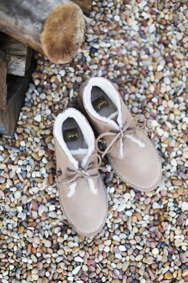 Penguin booties in stone - product lay down shot.