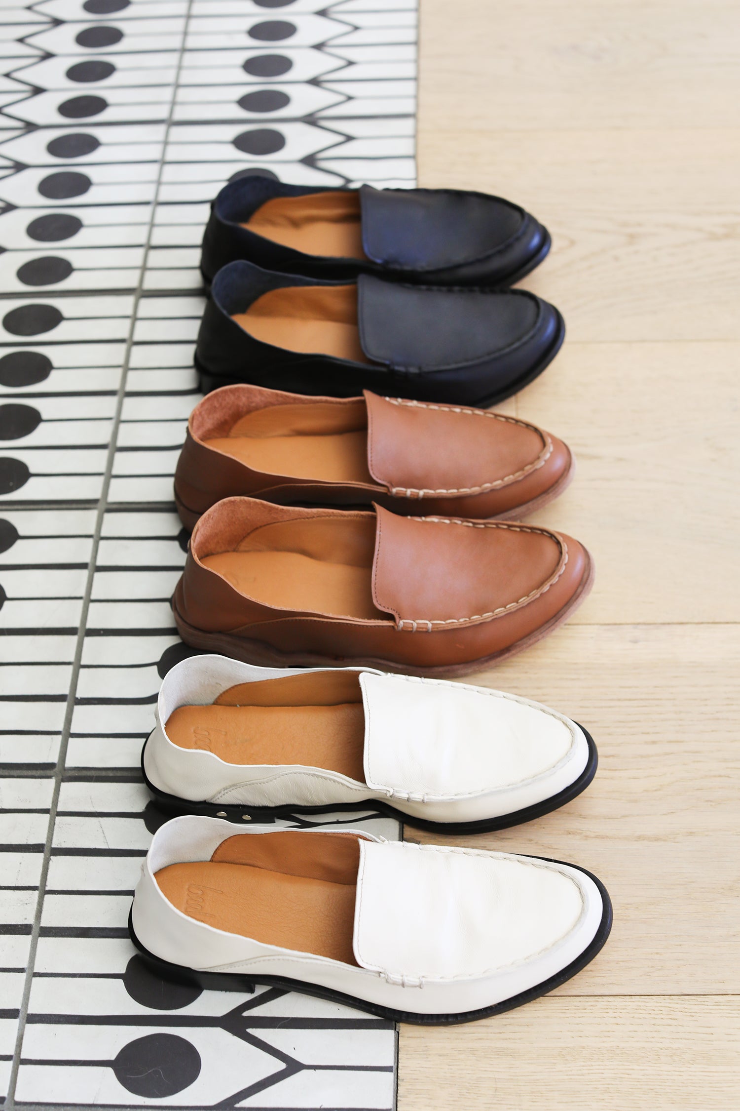 Group shot of Pepper leather loafer in eggshell, cognac, and black