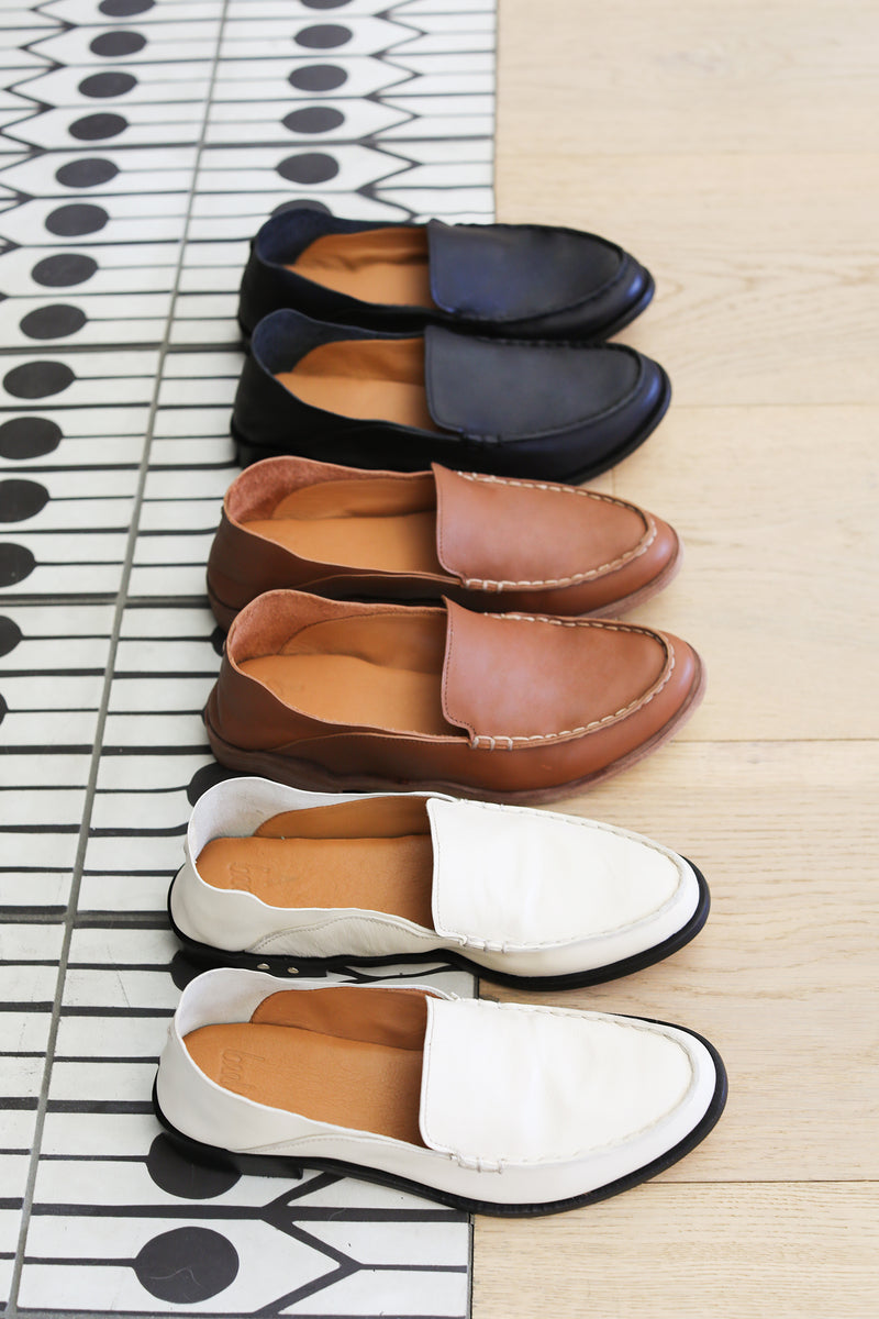 Group shot of Pepper leather loafer in eggshell, cognac, and black