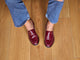 Woman wearing Pepper patent leather loafer in wine with jeans