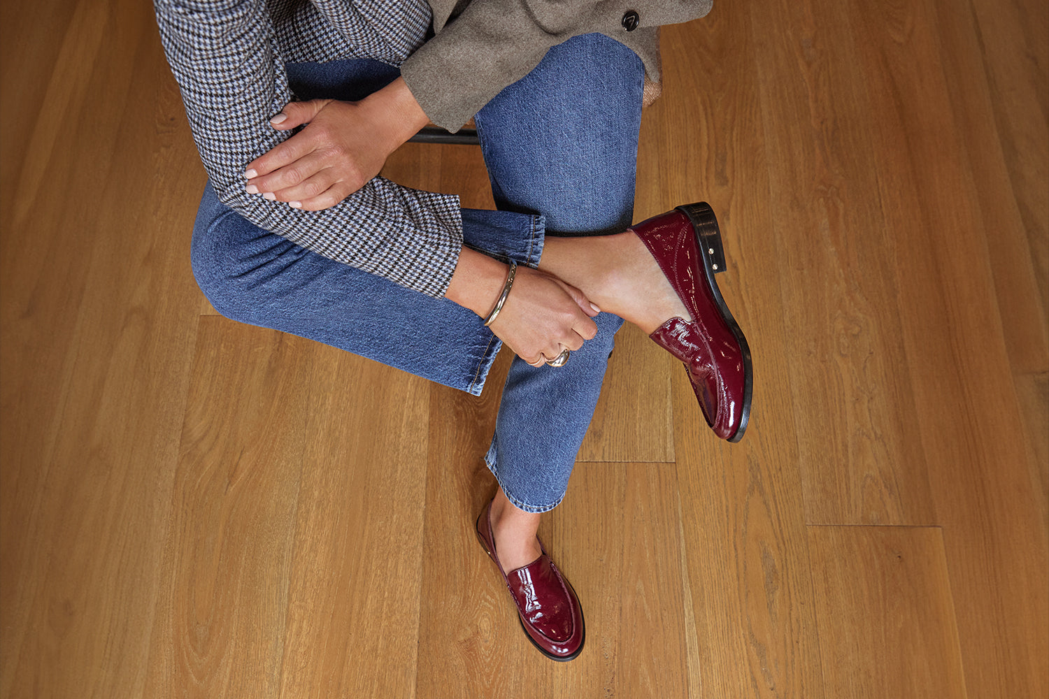 Woman wearing Pepper patent leather loafer in wine with jeans