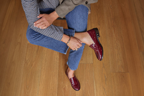 Woman wearing Pepper patent leather loafer in wine with jeans
