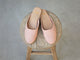 Phoebe Perforated leather ballet mule in blush on a wooden stool
