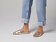 Video of woman walking in Gallito leather slide sandals in platinum wearing jeans