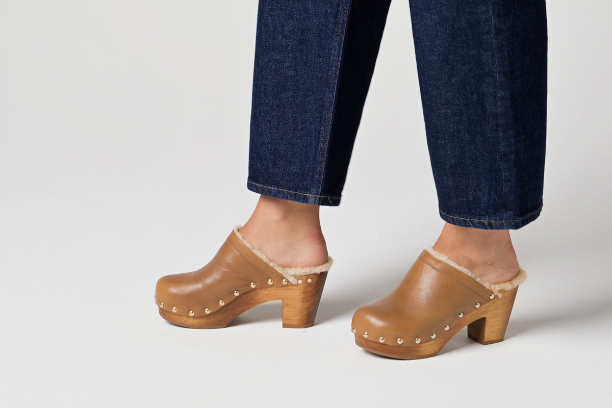 Video of woman wearing Woodpecker Shearling in saddle with dark cropped jeans, walking.