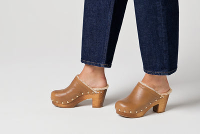 Video of woman wearing Woodpecker Shearling in saddle with dark cropped jeans, walking.
