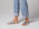 Video of woman walking in Starling leather slide sandals in silver wearing cuffed jeans