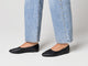Video of woman wearing Swoop leather ballet slippers in black with jeans, walking.