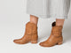 Video of women wearing Condor boots in tan with checkered dress, walking.
