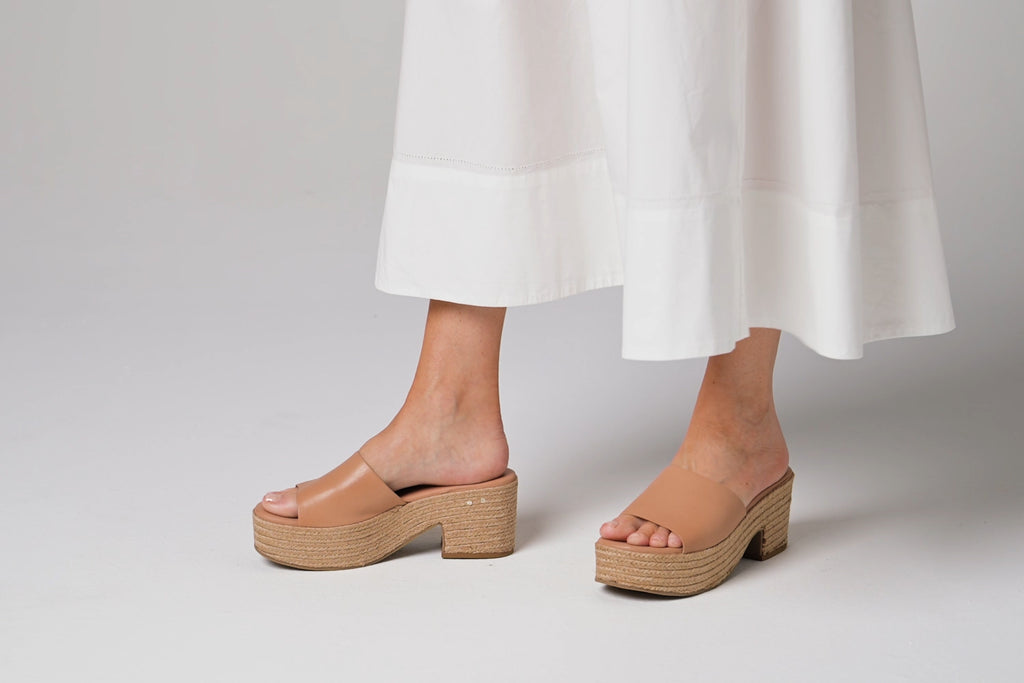 Woman wearing Prinia Jute leather heeled sandals in beach with white dress