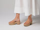 Woman wearing Prinia Jute leather heeled sandals in beach with white dress