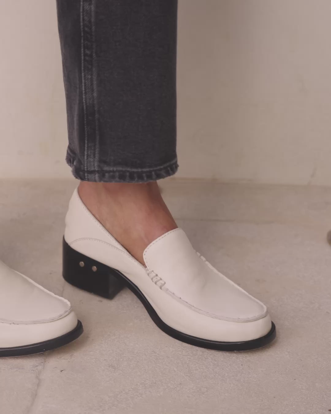 Video of woman wearing Owl leather loafer in eggshell with jeans, walking