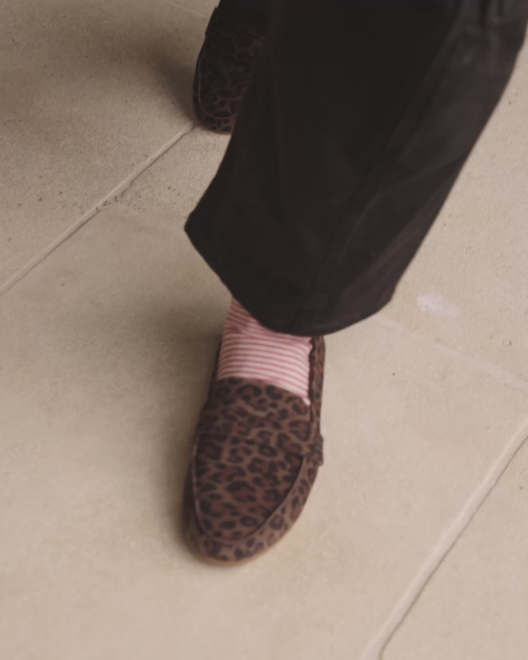 Video of woman wearing Moorhen suede loafers in leopard with striped socks and pants