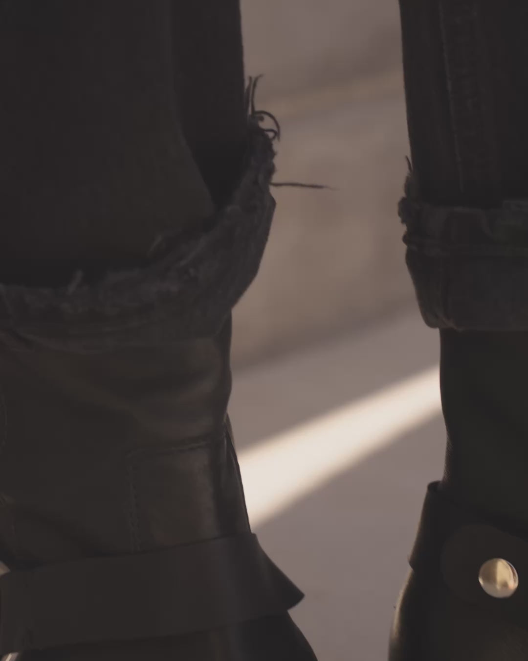 Video showing close up of Grackle leather boots with removable strap in black being worn with jeans