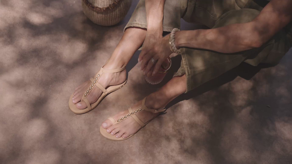 Video of woman wearing Goldenbird leather beaded ankle-strap sandal in beach