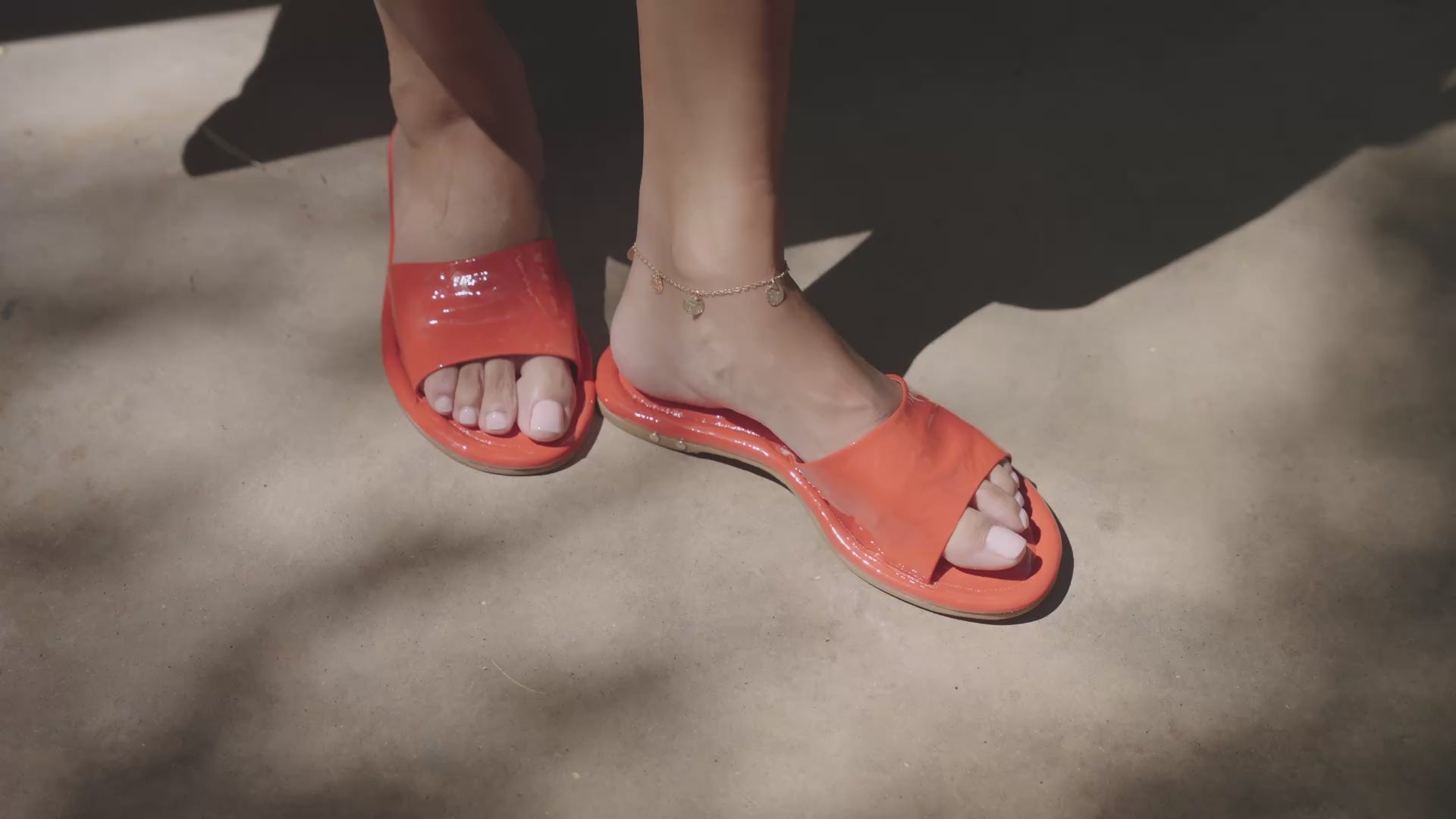 VIdeo of woman wearing Songlark leather slide sandal in patent leather tomato
