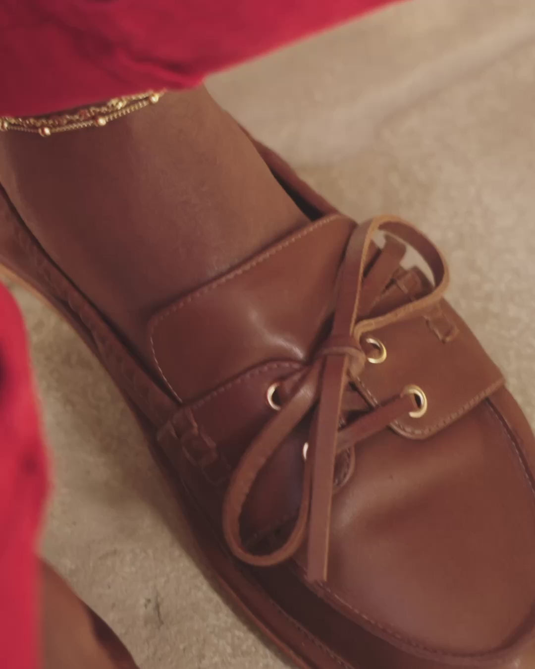 Woman wearing Boatbird leather boat shoes in cognac
