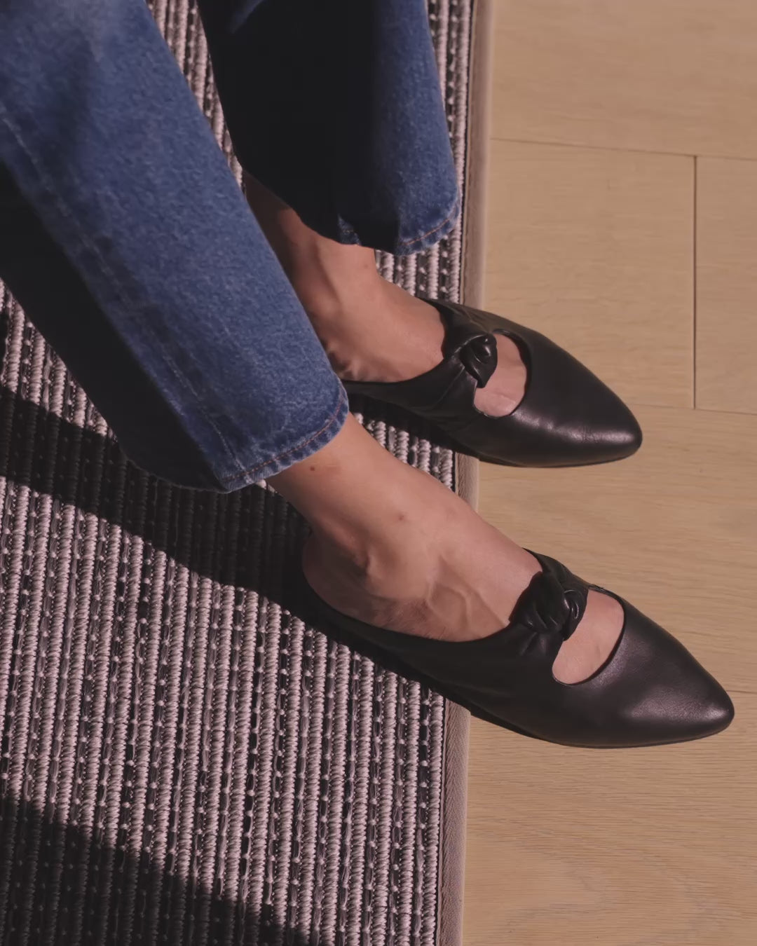 Video of woman wearing Noddy knotted mules in black with jeans, walking