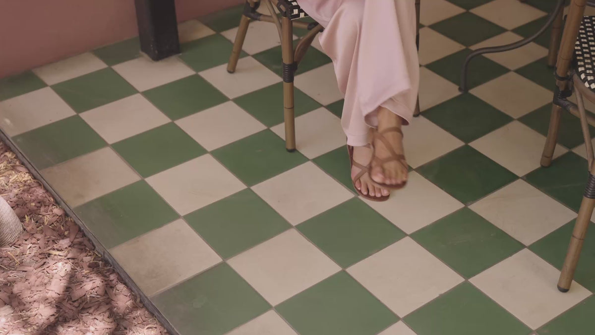 Video of woman wearing Linnet leather sandals in tan with pink pants sitting on chair