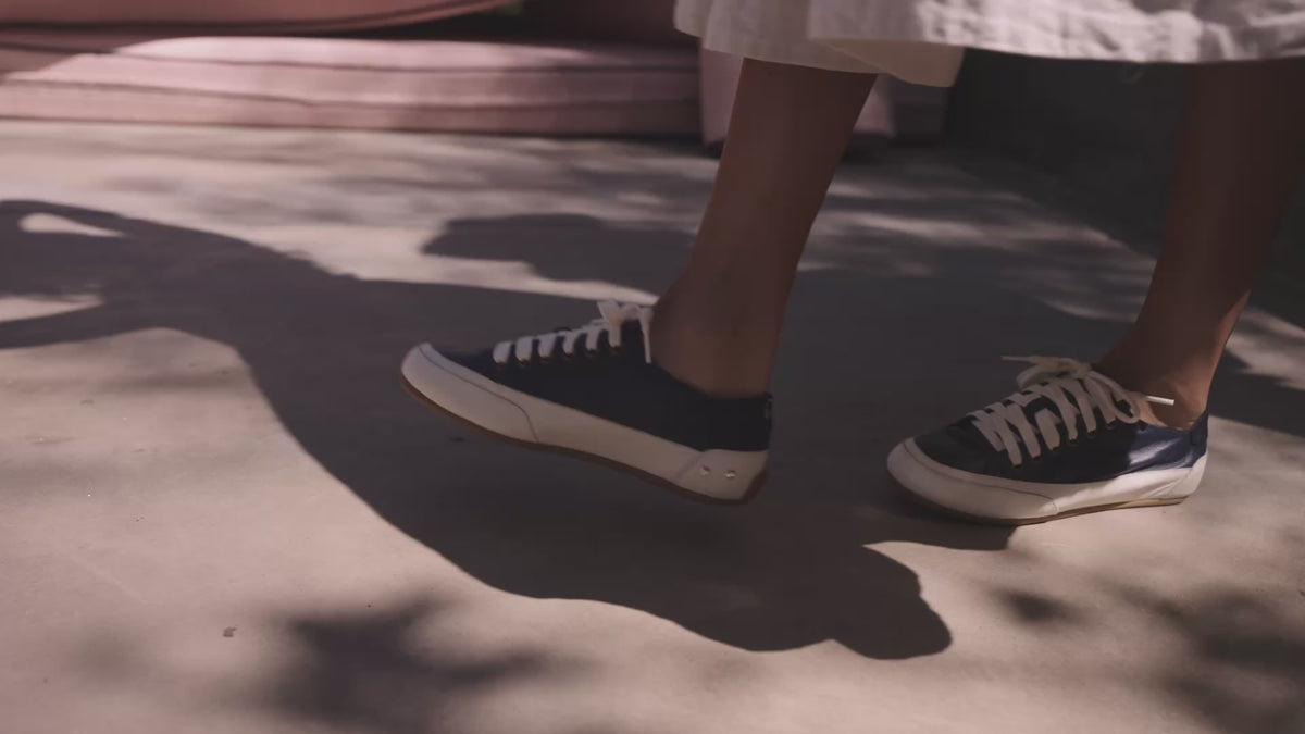 Video of woman wearing Sandpiper leather sneakers in navy