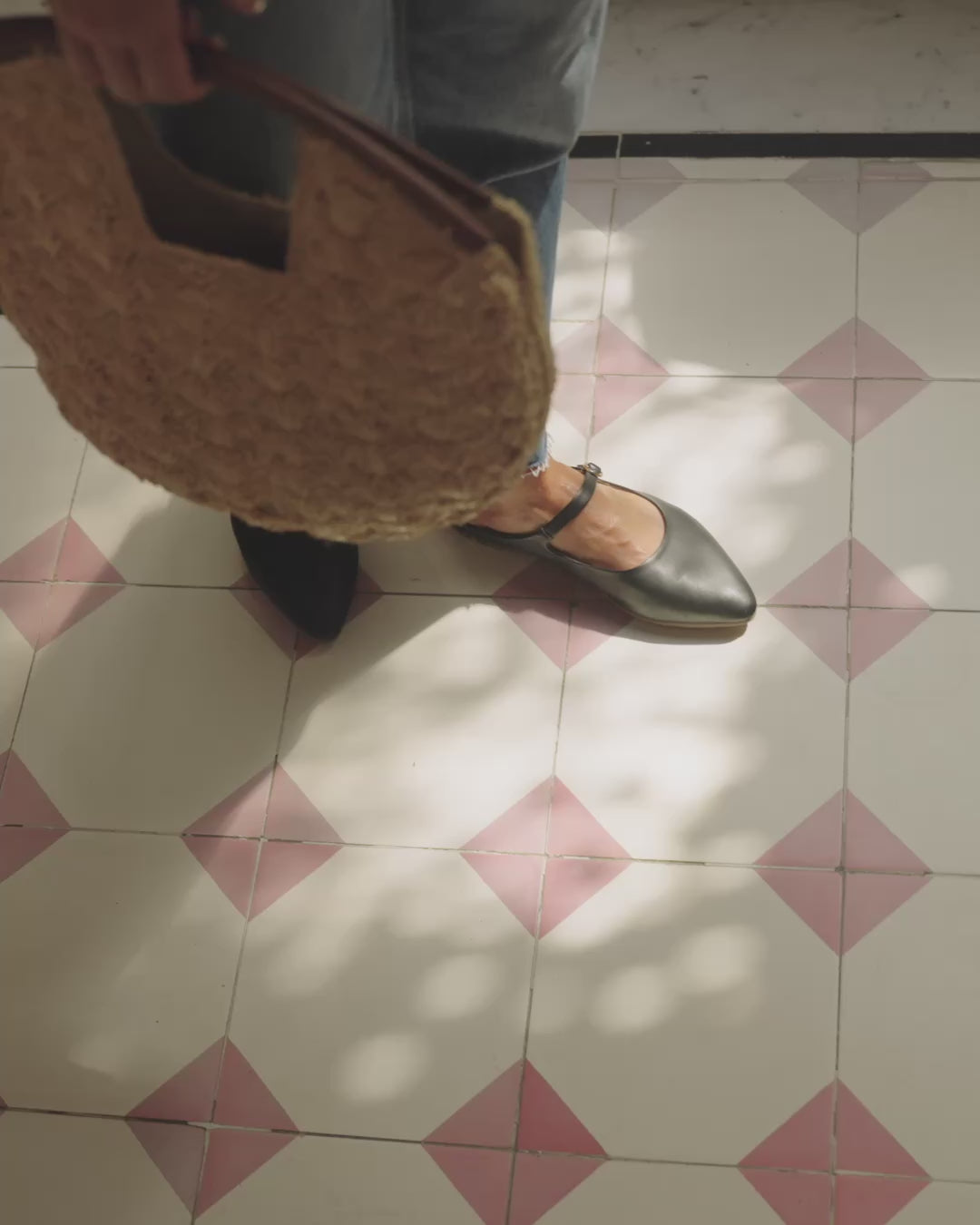Video of woman wearing Swallow leather shoes in black with jeans carrying a woven purse