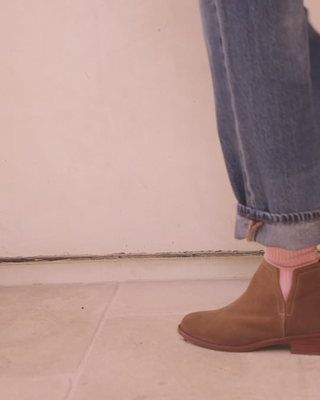 Video of woman wearing Falcon suede booties in chesnut with pink socks and jeans, walking outside