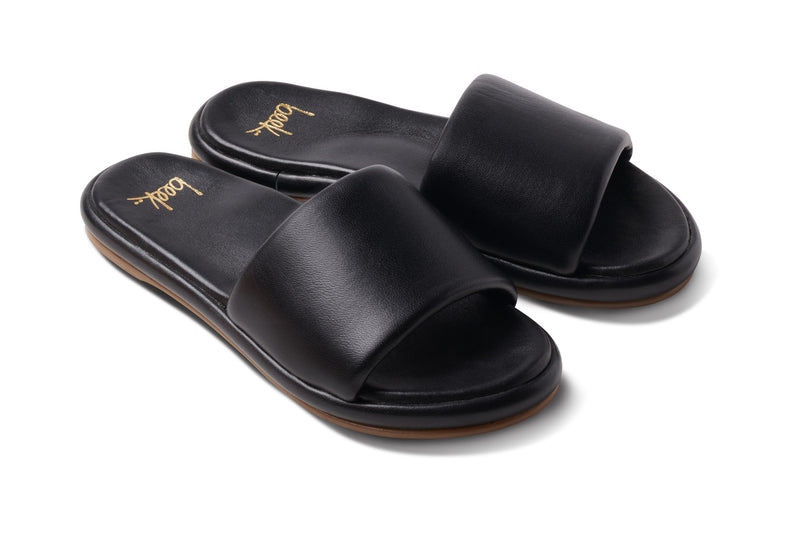 Puffbird leather slide sandal in black - angle shot