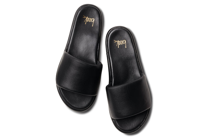Puffbird leather slide sandal in black - top shot