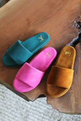 Puffbird suede slide sandals in forest, fuchsia, caramel - group shot