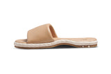 Puffbird Raffia leather slide sandal in beach - side shot