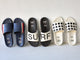 Group shot of Railibird leather slide sandals in stripe, surf, and dot against the wall