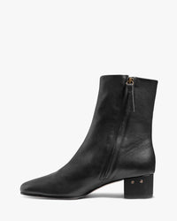 Raven leather heeled boots in black - product side shot
