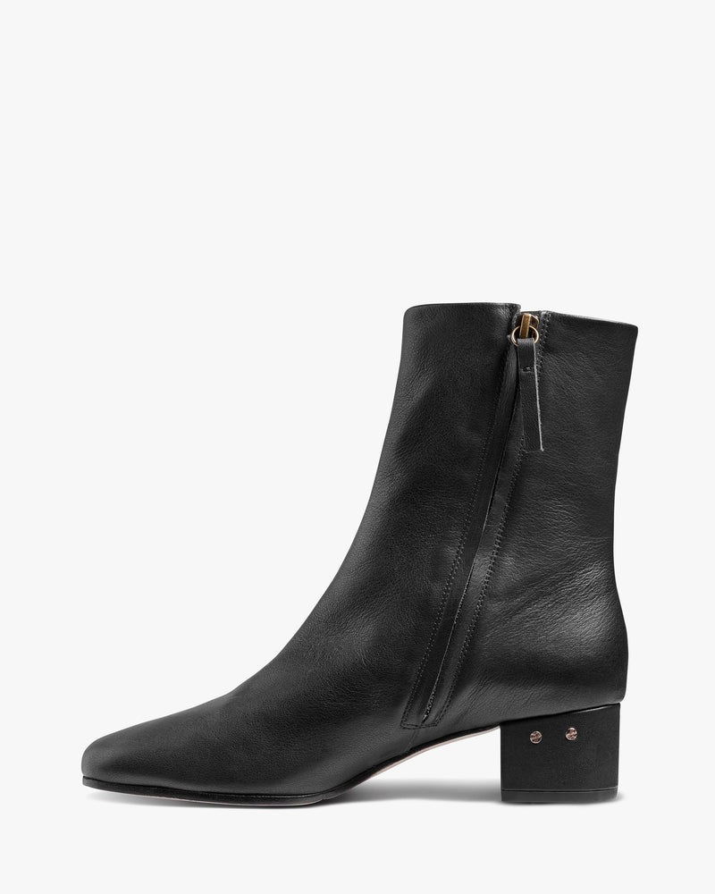 Raven leather heeled boots in black - product side shot