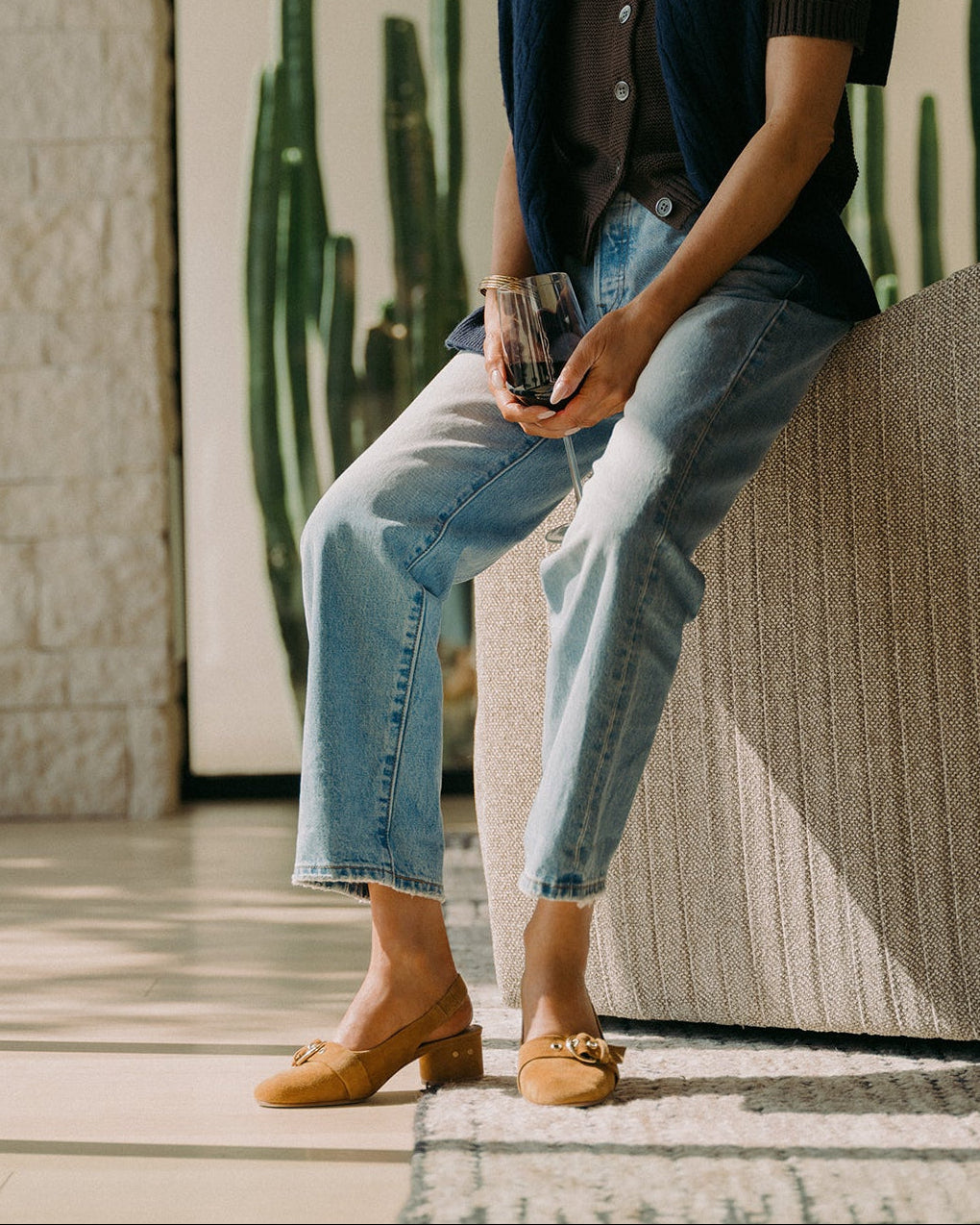 Woman wearing Rhea suede slingback heel in caramel with jeans and sweater
