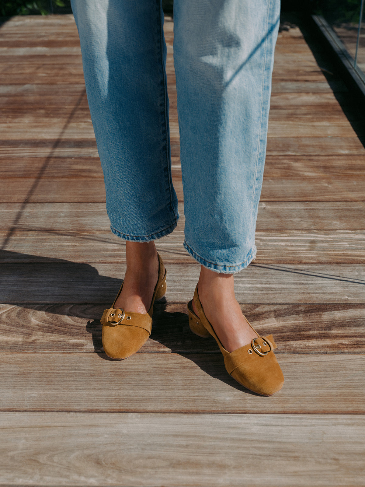 Woman wearing Rhea suede slingback heel in caramel with jeans