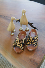 Robin leopard slide sandals in leopard on table