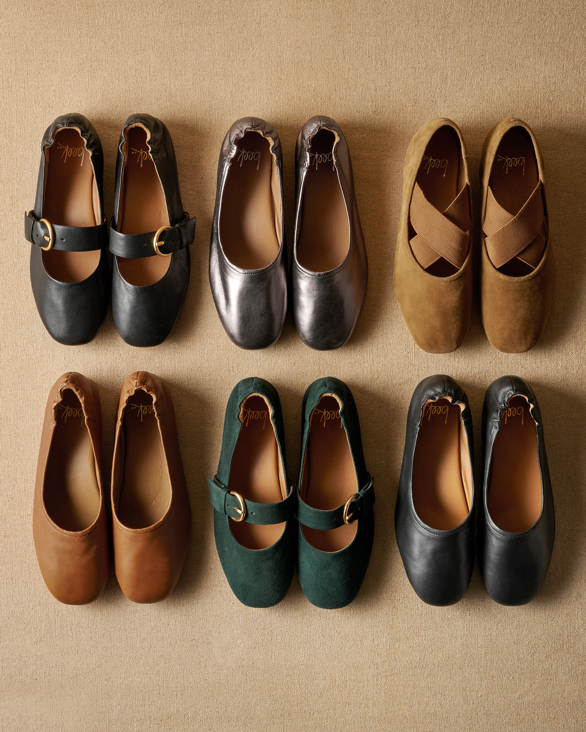 Group shot of Cardinal ballets in black leather and teal suede; Swan leather ballet flats in gunmetal, cognac, black; Serin suede ballet flats in toffee.
