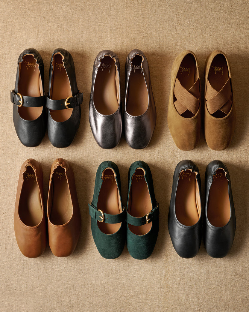 Group shot of Cardinal ballets in black leather and teal suede; Swan leather ballet flats in gunmetal, cognac, black; Serin suede ballet flats in toffee.