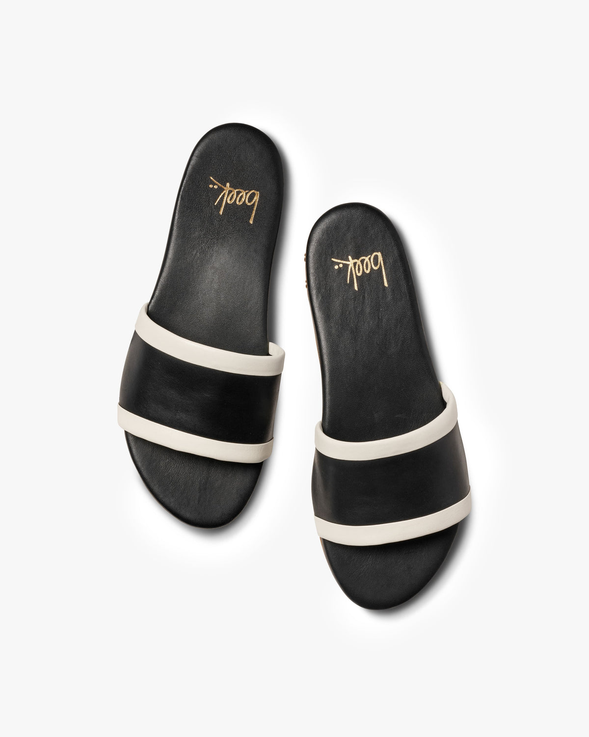 Shorebird leather slide sandals in black/vanilla - product side shot
