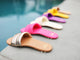 Group shot of Sugarbird leather slide sandals in gold/honey, azalea, eggshell, iris, sunflower, and beach