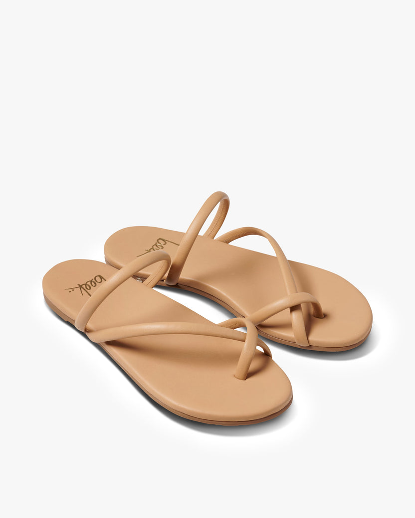 Sunbird leather slide sandals in beach - product angle shot