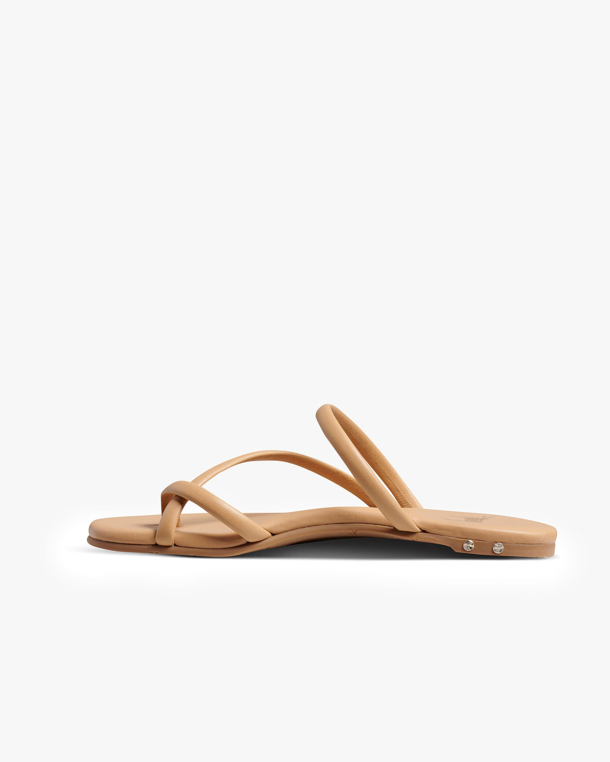 Sunbird leather slide sandals in beach - product side shot