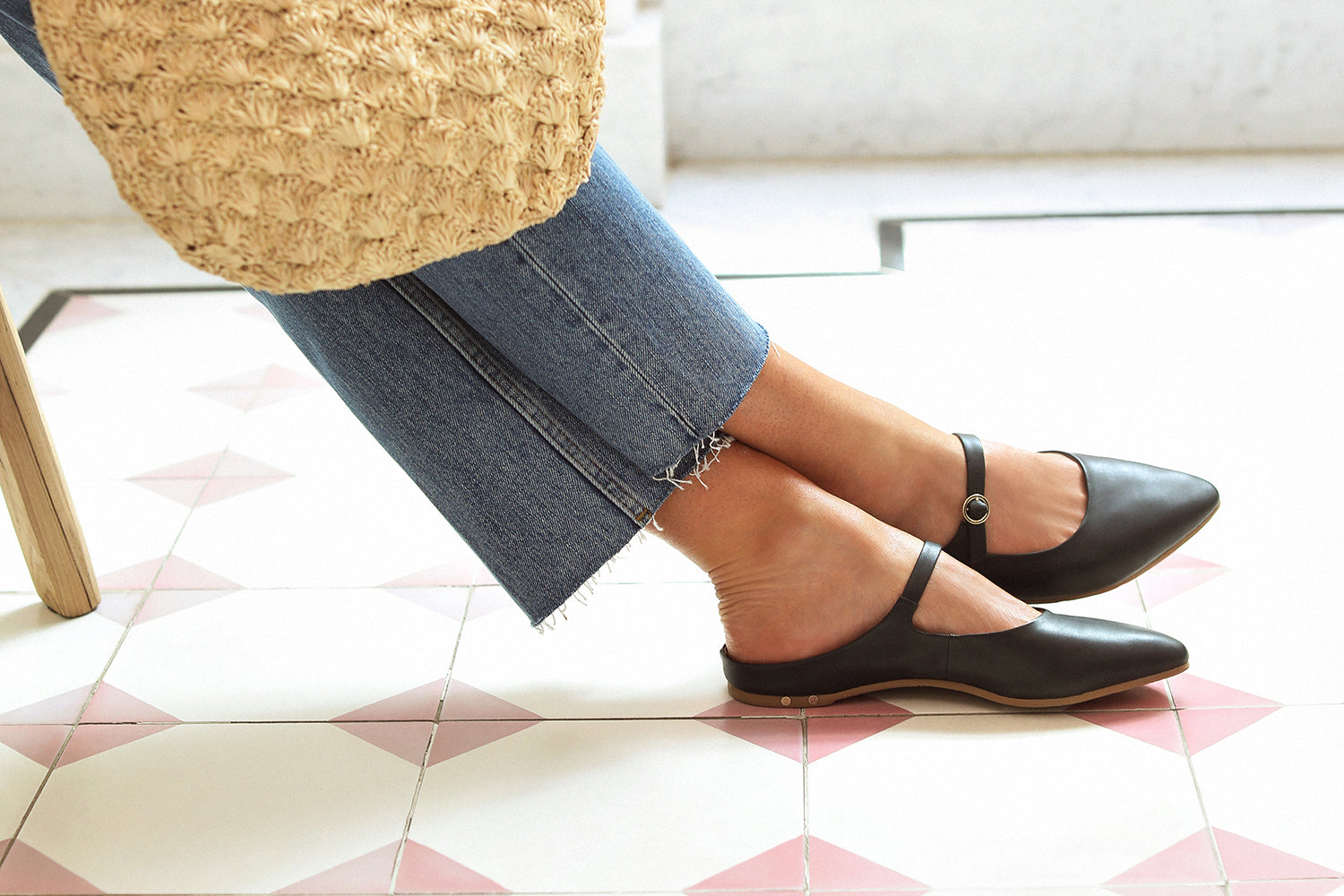 Woman wearing Swallow leather ballet mule in black with jeans