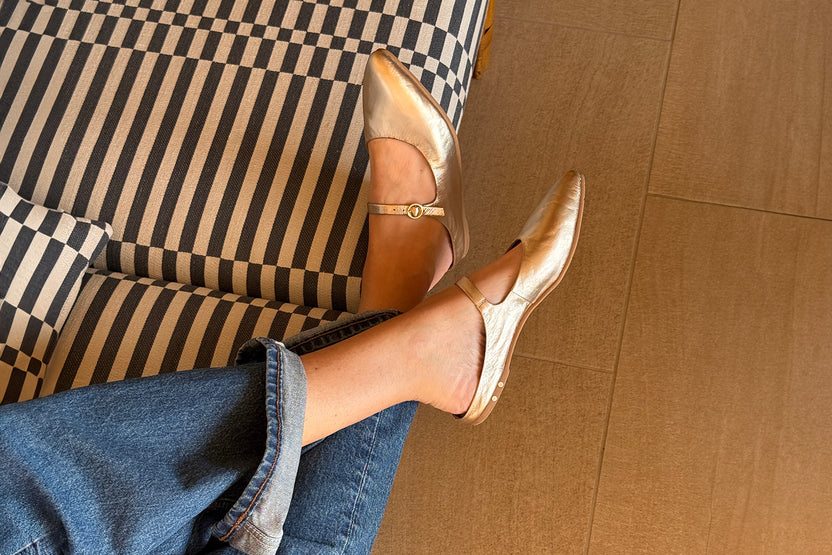 Woman wearing Swallow leather ballet mules in gold with jeans
