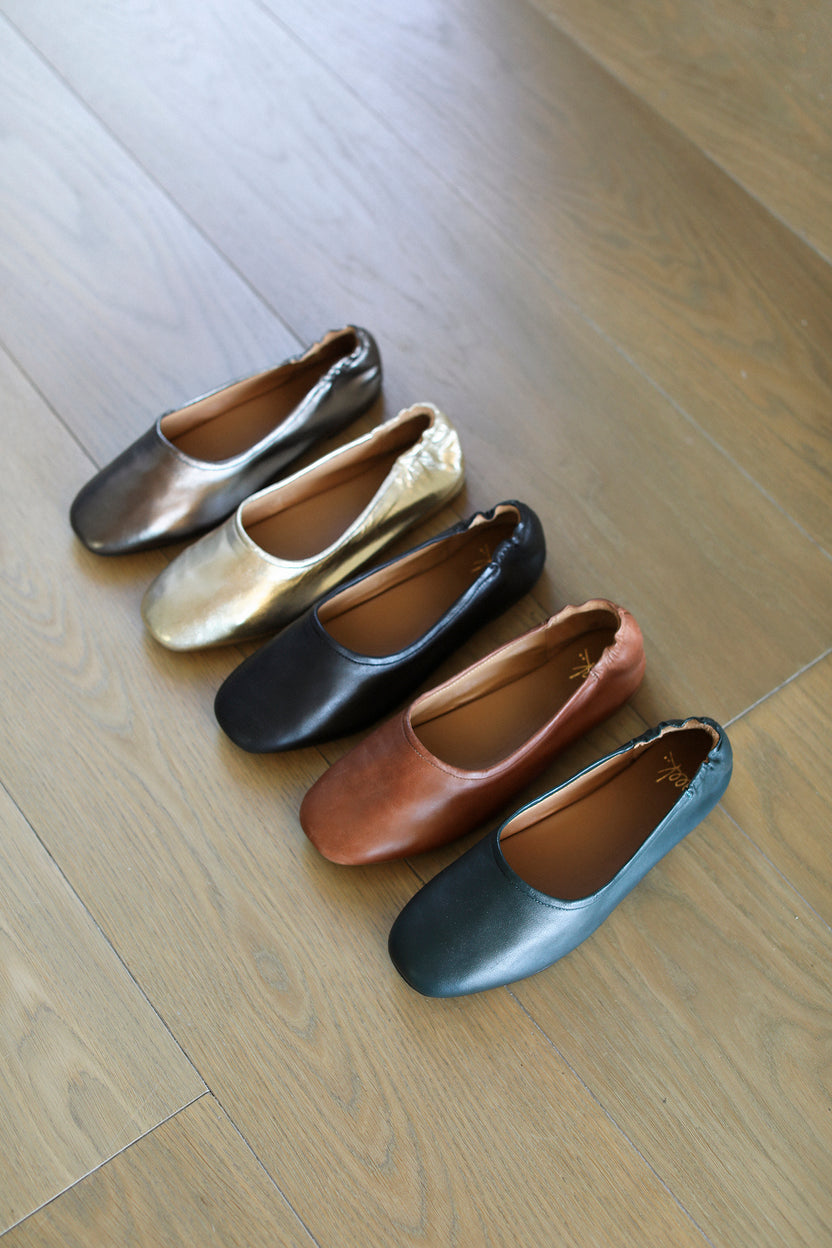 Group shot of Swan leather ballet flats in gunmetal, gold, black, cognac, teal.