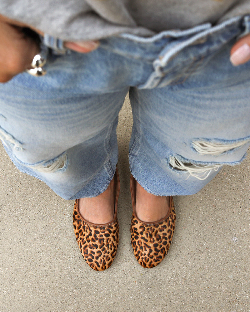 Woman wearing Swiftlet calf-hair and leather ballet slipper flats in leopard with jeans.