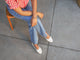 Woman wearing Swiftlet Perforated leather ballet slipper in vanilla with jeans and striped red shirt