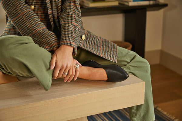 Woman wearing Swoop leather ballet slipper in black with olive pants and tweed jacket