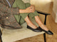 Woman wearing Swoop leather ballet slipper in black with olive pants and tweed jacket