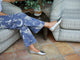 Woman wearing Swoop leather ballet shoes in silver with cowboy print pants
